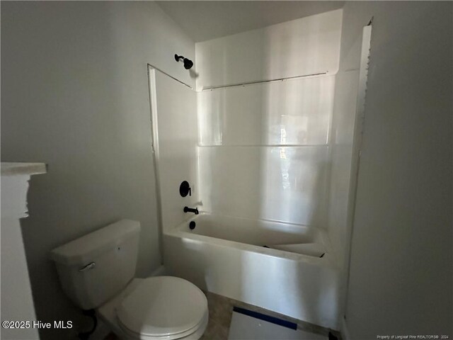 bathroom with shower / bathing tub combination and toilet