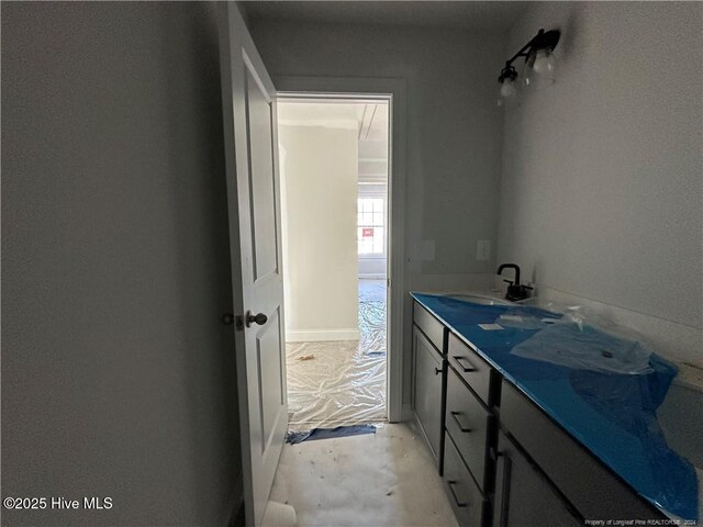 bathroom featuring concrete flooring and vanity