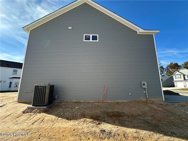 view of side of home with central AC unit