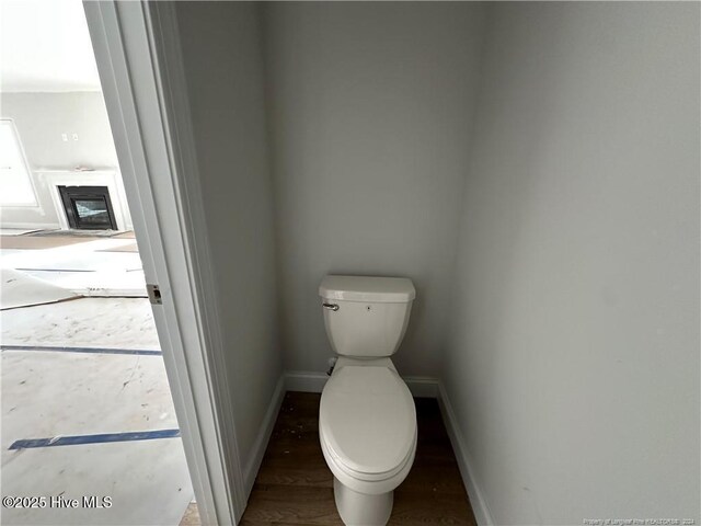 bathroom featuring hardwood / wood-style flooring and toilet