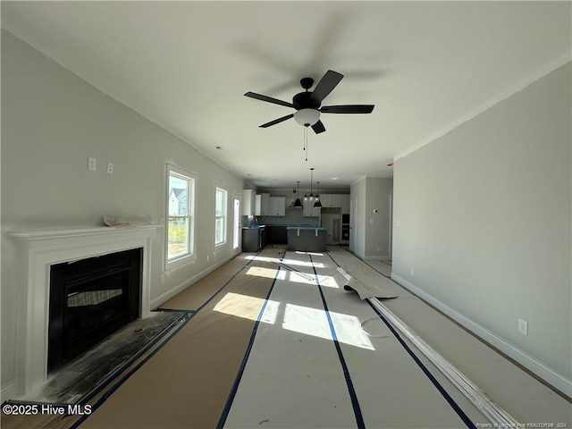 unfurnished living room featuring ceiling fan