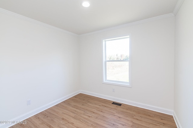 unfurnished room with light hardwood / wood-style flooring and ornamental molding