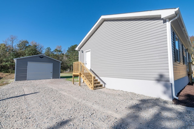 view of side of property featuring an outbuilding and a garage