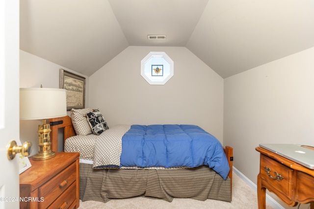 carpeted bedroom with vaulted ceiling