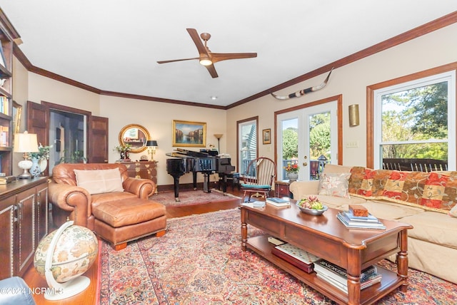 living room with a wealth of natural light, ornamental molding, and french doors