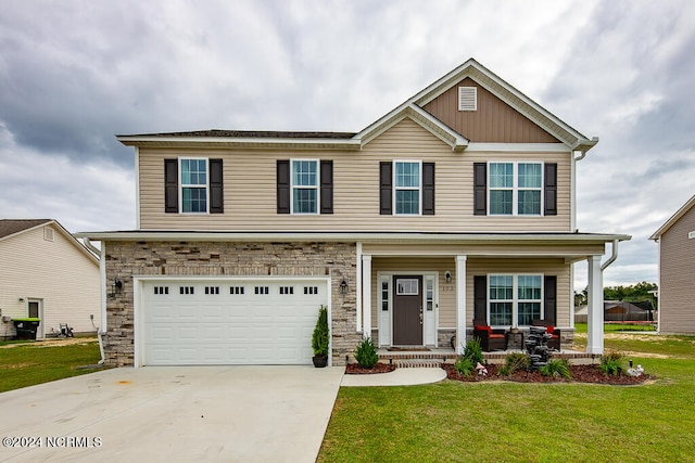 craftsman-style home featuring a front yard, a garage, and covered porch