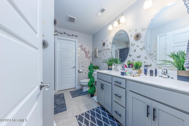 bathroom featuring tile patterned flooring, vanity, and toilet