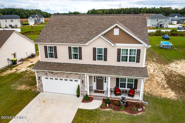 view of front of home featuring a front lawn and a garage