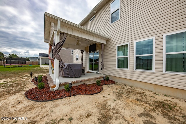 view of patio / terrace with a trampoline, area for grilling, and ceiling fan