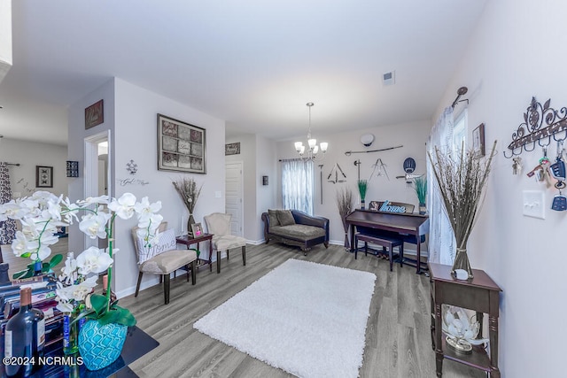 living room featuring a notable chandelier and wood-type flooring