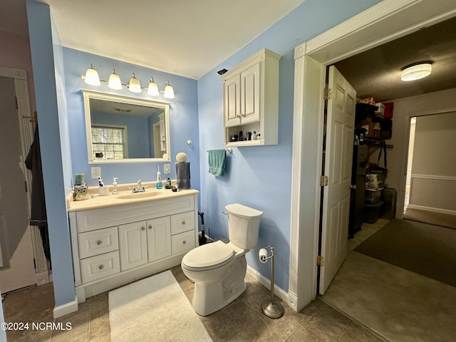 bathroom with vanity, tile patterned floors, and toilet