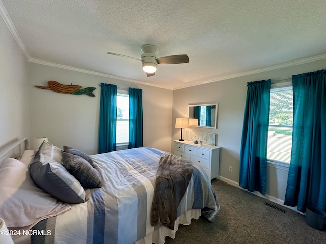 bedroom featuring ceiling fan, ornamental molding, a textured ceiling, and dark colored carpet