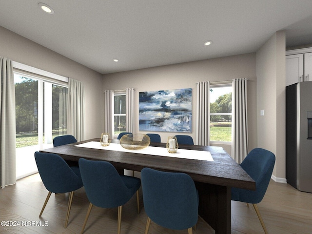 dining room with a healthy amount of sunlight, light wood finished floors, and recessed lighting