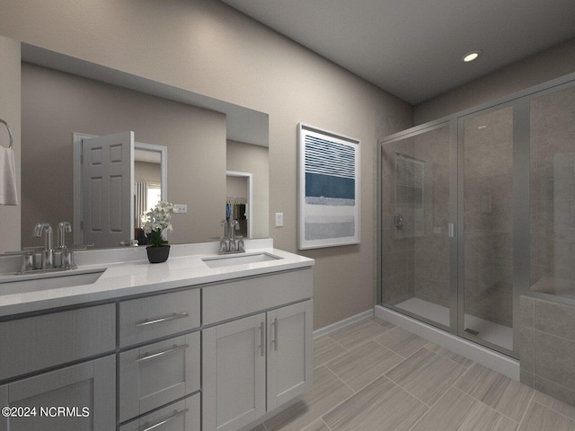 bathroom featuring double vanity, a shower stall, and a sink