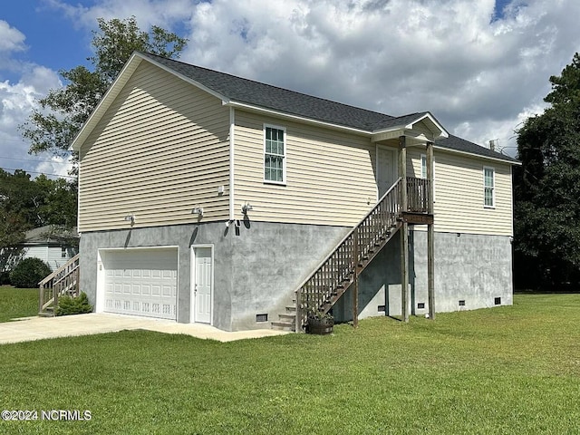 exterior space featuring a garage and a yard