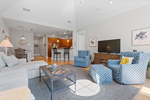 living room featuring light hardwood / wood-style flooring and a chandelier