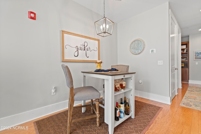 dining area featuring light wood-type flooring and a chandelier