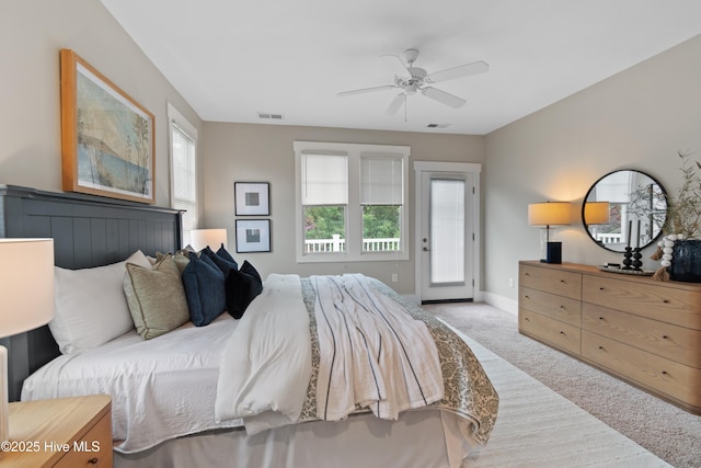 2537 St James Dr SE Unit 303, Southport, NC 28461 - bedroom with carpet floors, access to exterior, baseboards, and a ceiling fan
