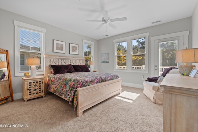 carpeted bedroom featuring ceiling fan and access to outside