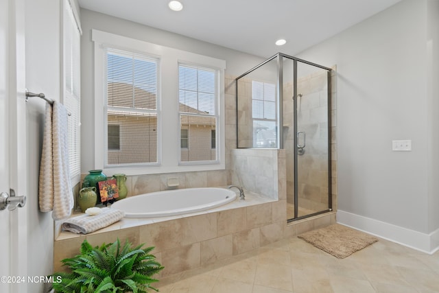 bathroom featuring plus walk in shower and tile patterned flooring