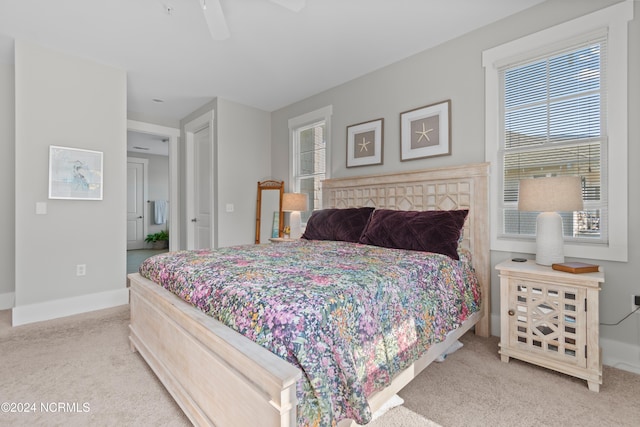 bedroom featuring ceiling fan and light carpet