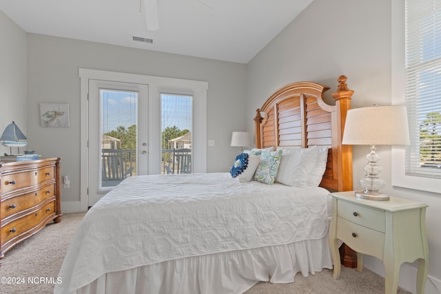 bedroom featuring light carpet, lofted ceiling, ceiling fan, and access to exterior