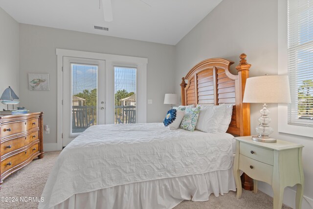 2537 St James Dr SE Unit 303, Southport, NC 28461 - bedroom featuring light colored carpet, french doors, access to outside, and a ceiling fan