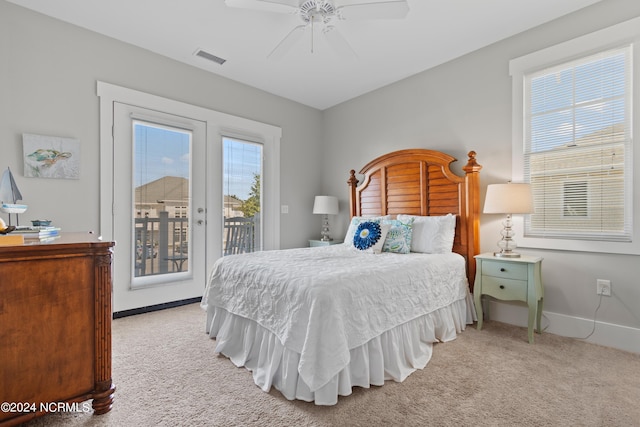 bedroom featuring multiple windows, ceiling fan, and light colored carpet