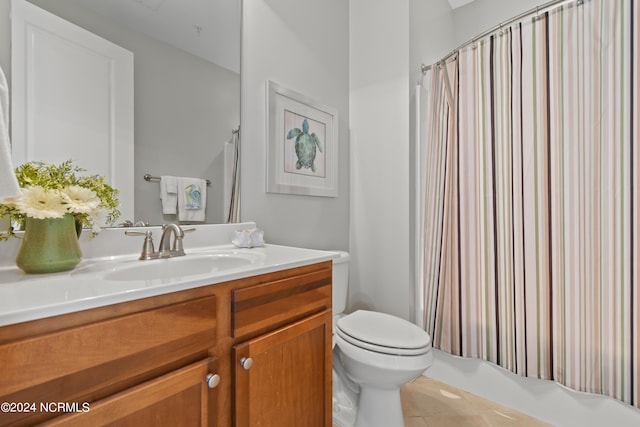 full bathroom with shower / bath combo with shower curtain, tile patterned floors, vanity, and toilet