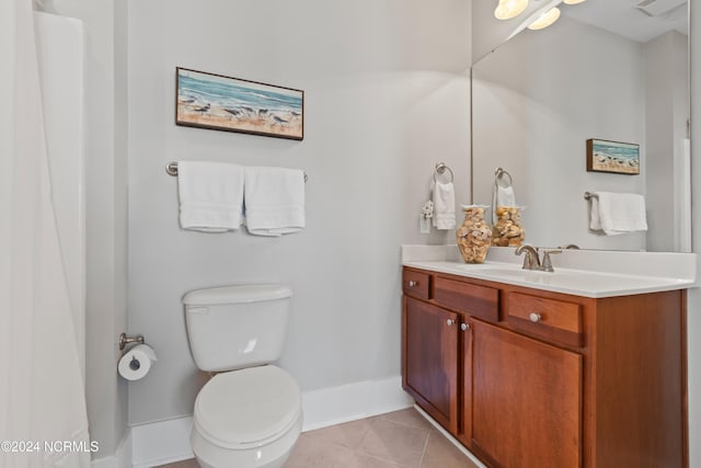 bathroom with tile patterned flooring, vanity, and toilet