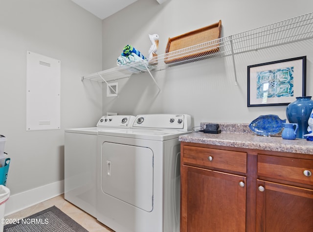 clothes washing area featuring separate washer and dryer and light tile patterned flooring