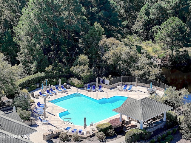 2537 St James Dr SE Unit 303, Southport, NC 28461 - community pool featuring a gazebo, a patio area, and a view of trees