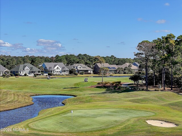 2537 St James Dr SE Unit 303, Southport, NC 28461 - surrounding community featuring a water view, a residential view, view of golf course, and a putting green