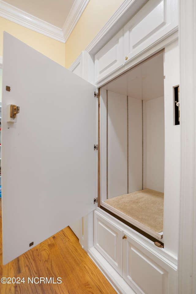 interior space featuring hardwood / wood-style flooring and ornamental molding