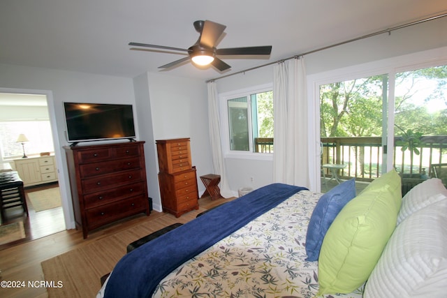 bedroom with access to outside, wood-type flooring, and ceiling fan