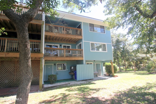 rear view of property featuring a lawn