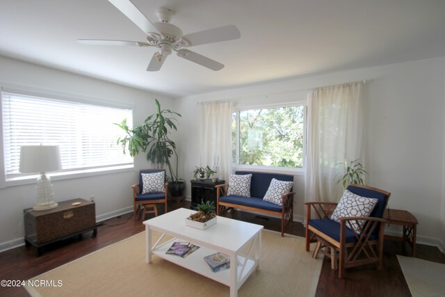 living room with ceiling fan and dark hardwood / wood-style floors