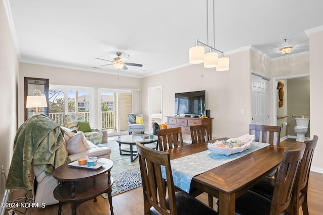 dining area with light hardwood / wood-style flooring and crown molding