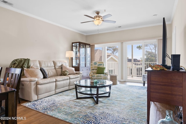 living room featuring ornamental molding, ceiling fan, and hardwood / wood-style floors