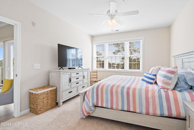 bedroom with light carpet and ceiling fan