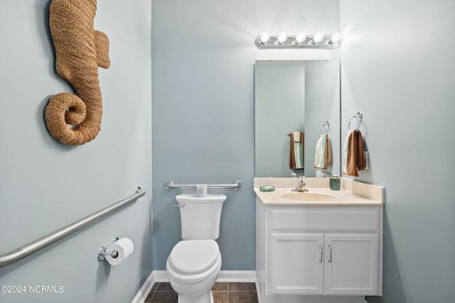 bathroom featuring tile patterned flooring, vanity, and toilet