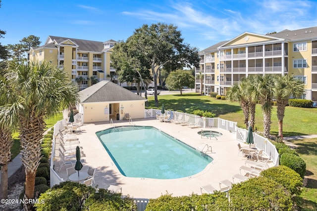 view of swimming pool with a patio and a yard