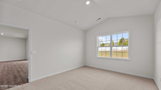 carpeted empty room with recessed lighting, visible vents, baseboards, and vaulted ceiling