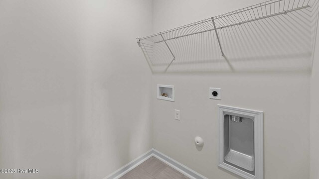 laundry area with washer hookup, hookup for a gas dryer, baseboards, hookup for an electric dryer, and laundry area