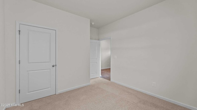 unfurnished bedroom with baseboards and carpet floors