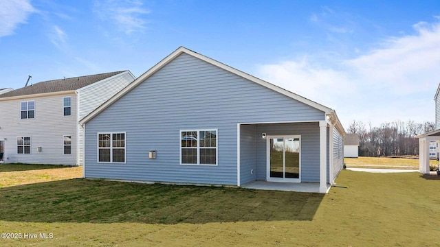 back of property featuring a yard and a patio area