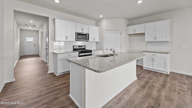 kitchen with white cabinetry, stainless steel appliances, dark wood-type flooring, and a sink