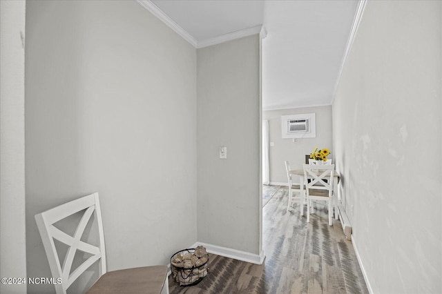 corridor featuring crown molding, baseboards, wood finished floors, and a wall mounted air conditioner