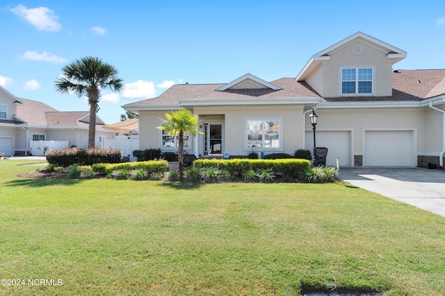 view of front of house featuring a front yard and a garage