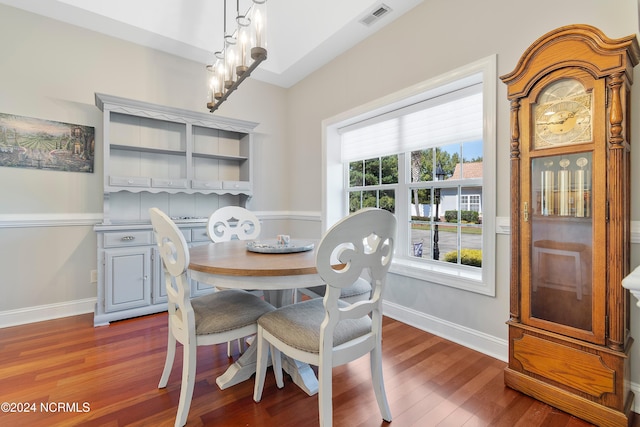 dining room with wood-type flooring and a notable chandelier